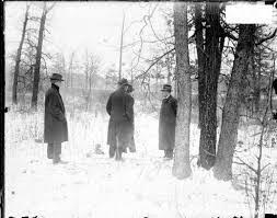 A group of people standing on top of a snow covered forest