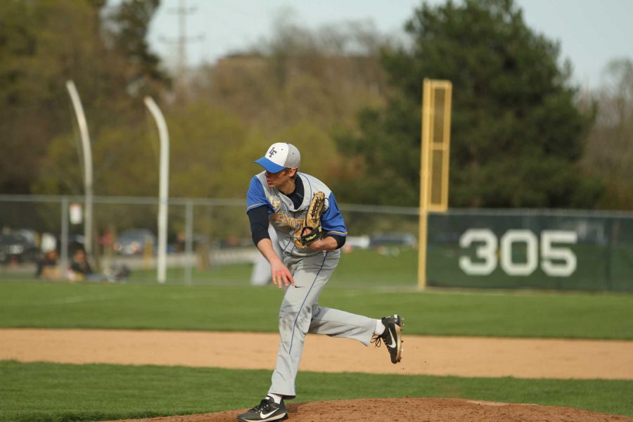 A baseball player pitching a ball on a field
