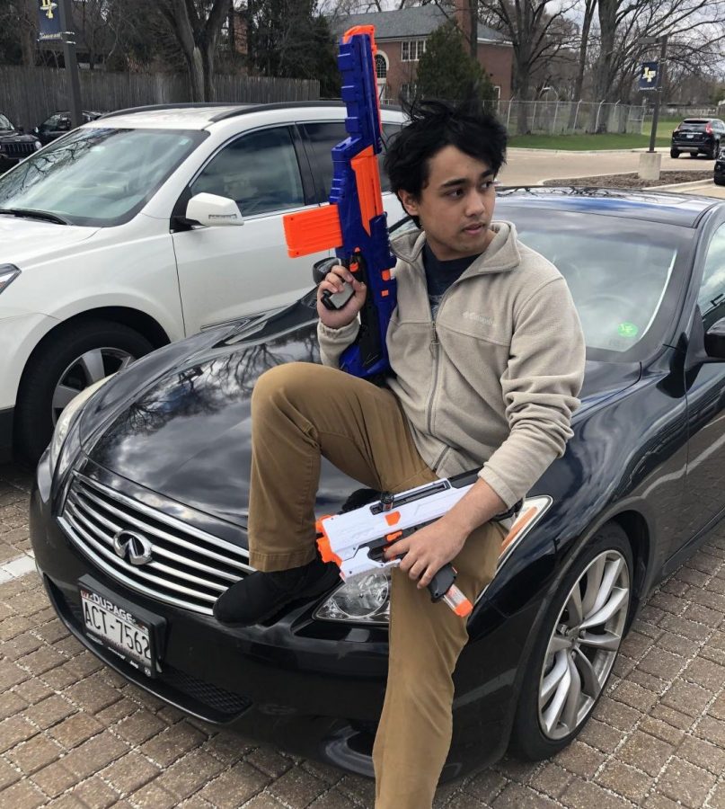 Zeyad Alam, the mastermind behind  Paranoia, rests on his car moments before the chaos begins. More than 300 seniors are participating in the Nerf war.