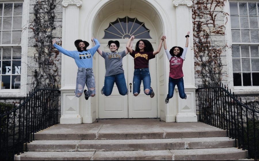 Seniors Rana Muratoglu, Nikole Tzioufas, Hope Marwede, and Maddy Javier celebrate their college decisions in front of the doors of their soon to be alma mater. 