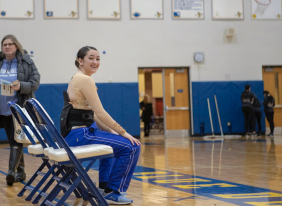 Marissa Giangorgi, then a junior, sits out during a competition. Sidelined by a back injury, she helped coach the team as they advanced to Nationals.