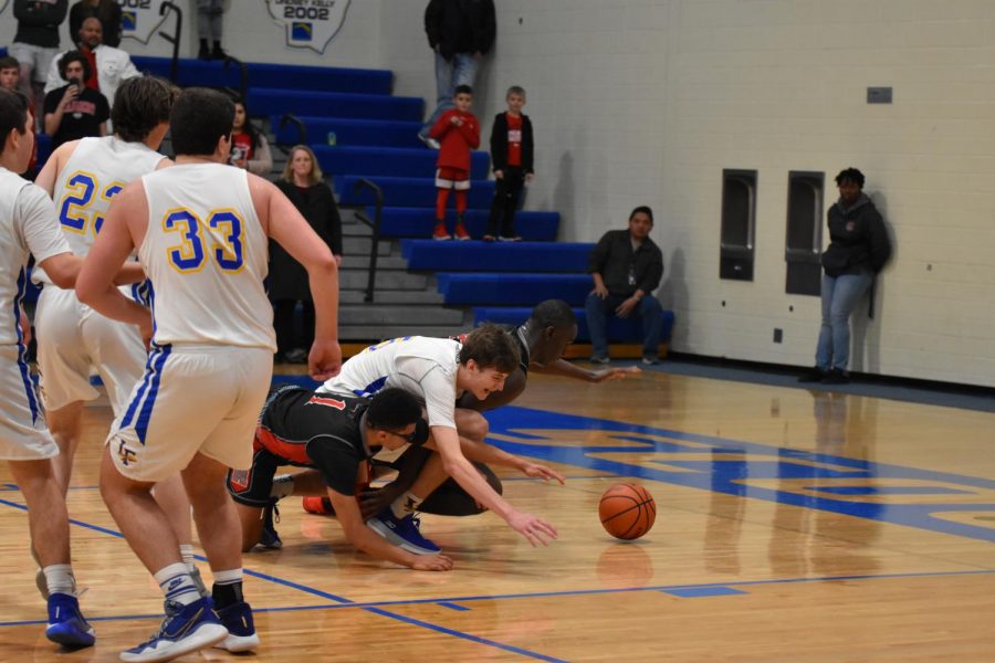 Chaos in the Comp Gym: Asa Thomas battles Trey Baker and Scottie Ebube for a loose ball under the Mustangs’ basket as Cade Nowik, Jack Malloy, and Stephen Young look on.