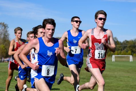 Nate Schmitt and Ben Rosa running at the North Suburban Conference Cross Country meet in October.