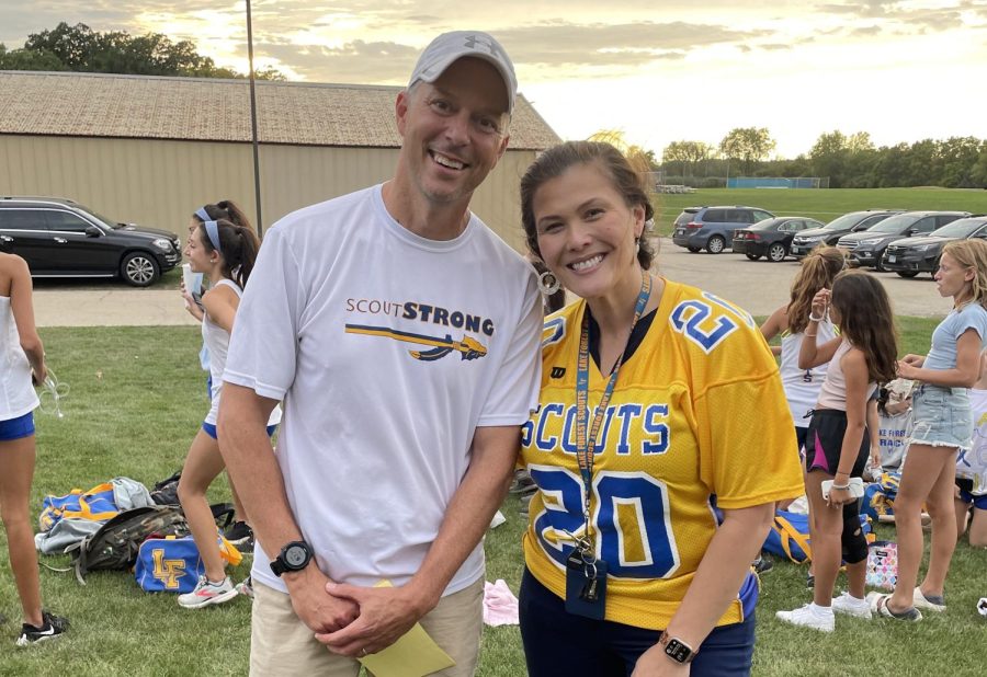 Dr. Lenart, pictured with girls cross country coach Steve Clegg, showing her support at their senior night race