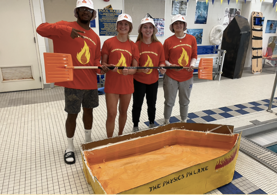 The Physics Phlame posing with their winning boat.