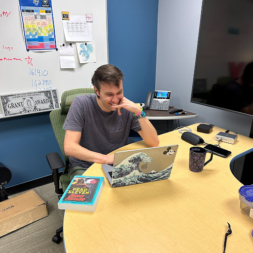 Juliano in his EdTech office with his novel, which is set to release June 27 of this year