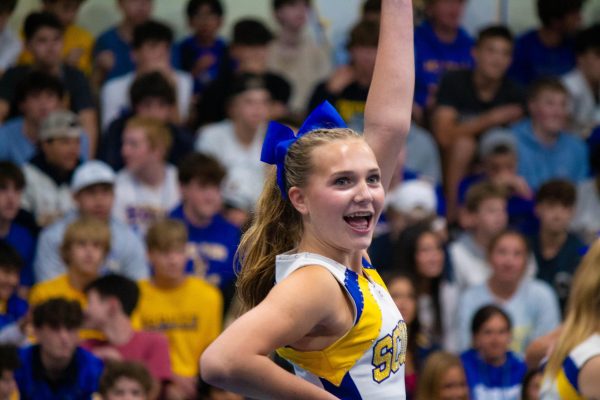 Sam Schacher cheering with a bright smile.