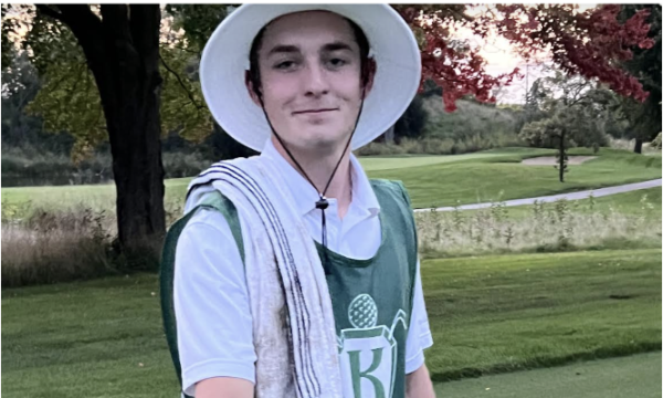 Senior Connor Harling caddying at Knollwood Golf Course.