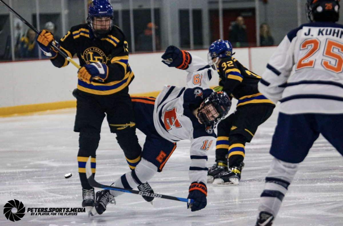 Senior Thomas Santinello hits an Evanston player. Santinello joined the Scouts hockey program this year after playing for the AAA Milwaukee Admirals. 
