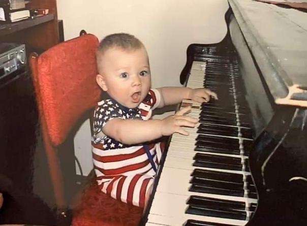 Dan learning to play the piano as a toddler (Courtesy of Tim Dan)