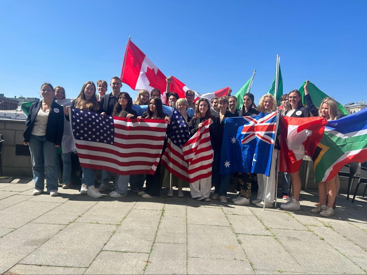 Jill+with+other+Norwegian+students+holding+up+flags+of+the+countries+they+would+spend+their+exchange+year+in.+%28Courtesy+of+Jill-Marie+Berg%29