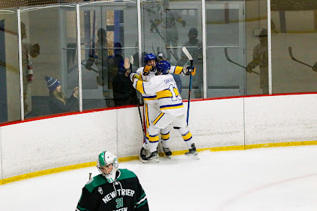 Seniors Thomas Santinello and Andrew Marsch celebrate after a game-tying one-timer in the first period. 
