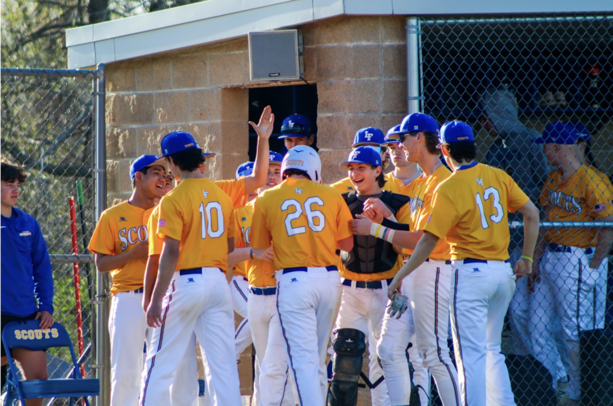 The team celebrating after Colin Sinclair scores a run.