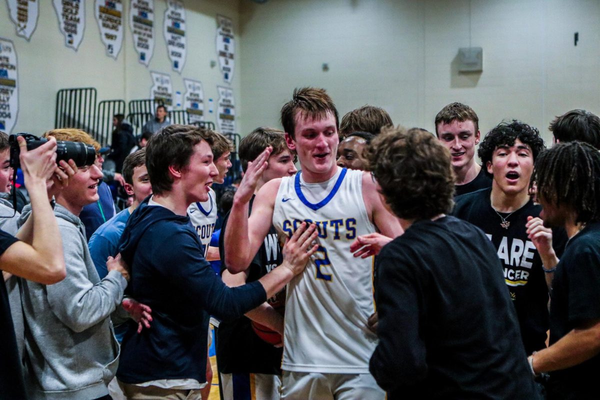 Aberle celebrating with teammates after his buzzer beater layup 