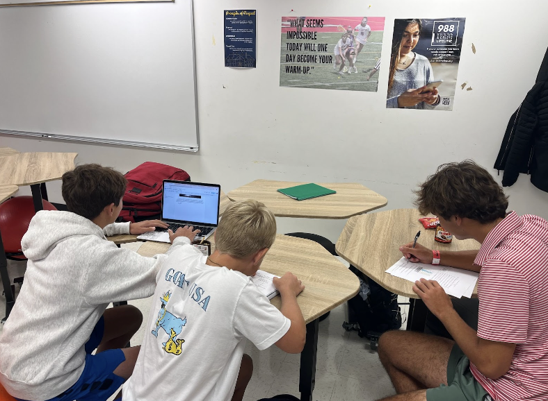 Coach Cats' class with Sawyer Rice, Miller Duncan, and Camden Scroggins at work - Courtesy of Cate Lee