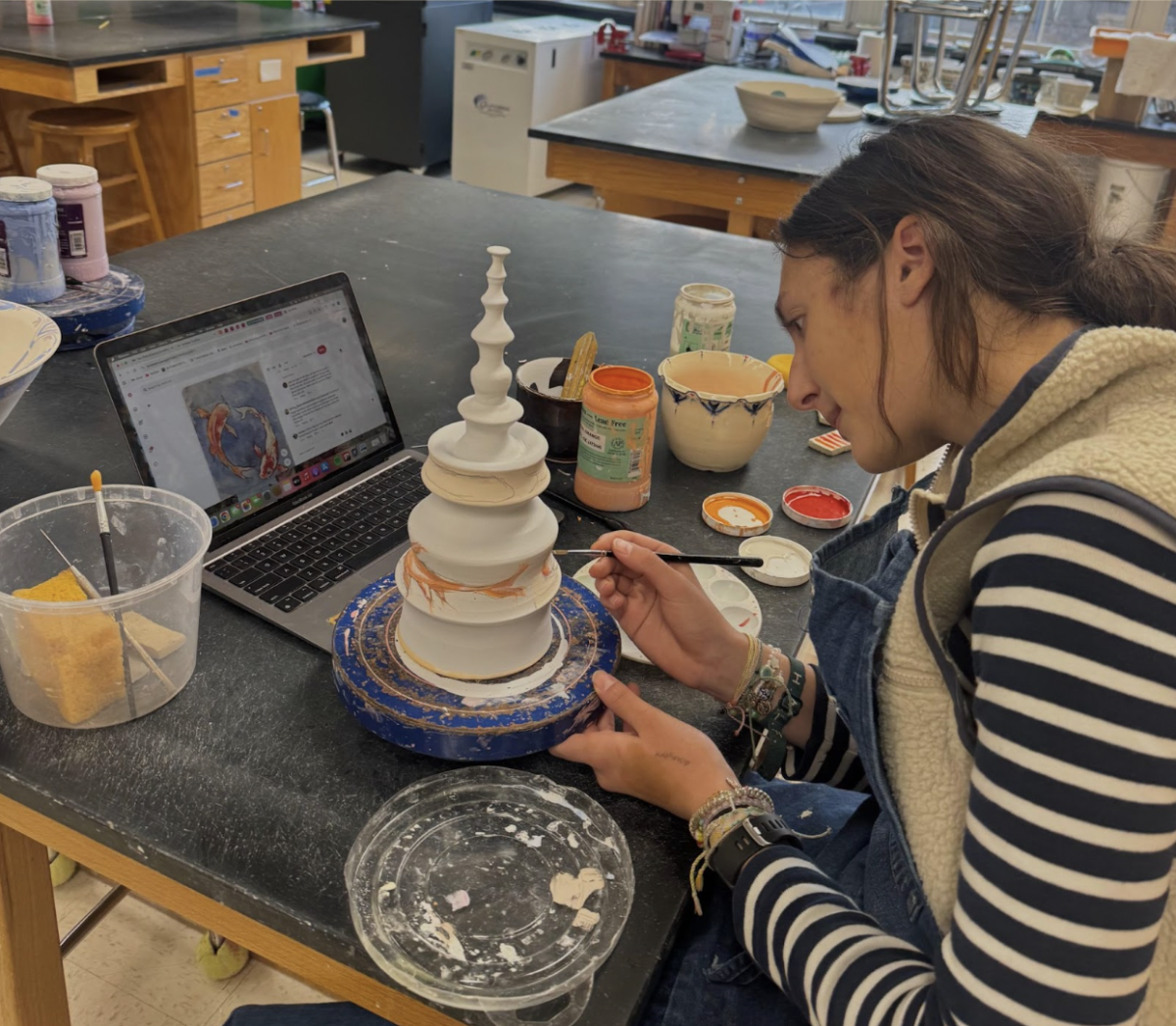 Gabby underglazing one of her pieces. 