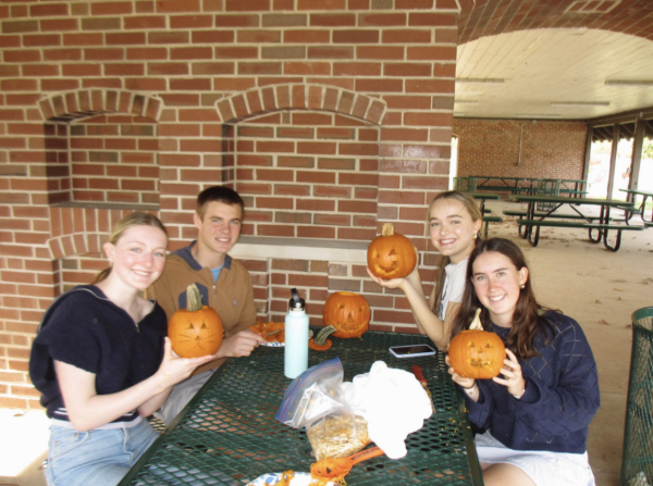 Students in Integrated Wellness carving pumpkins.
