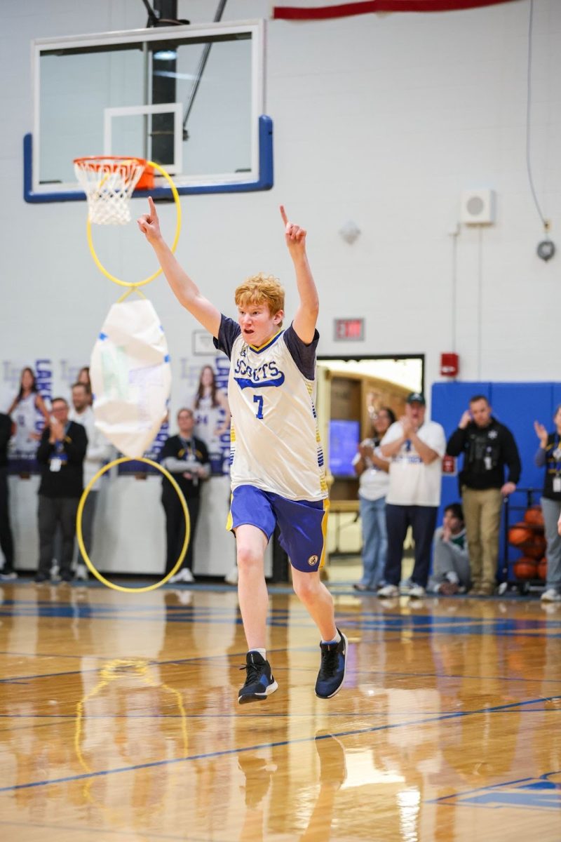Sophomore Joey Van Camp celebrating the win after they beat New Trier in the ELS Basketball game.