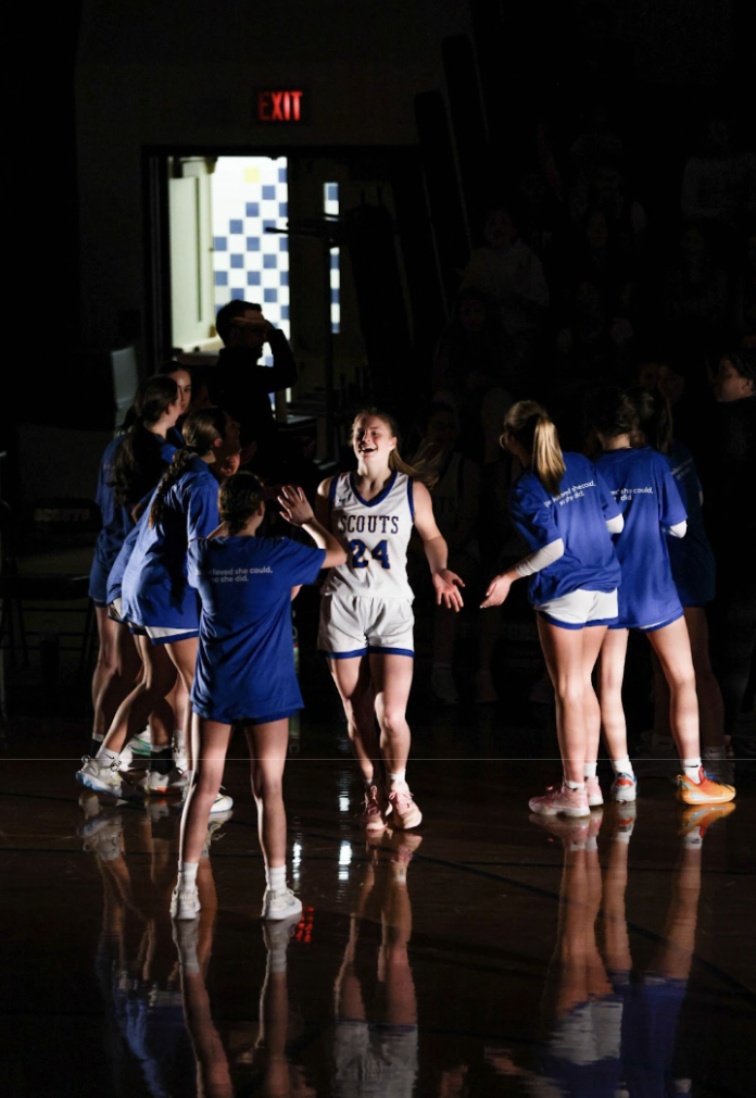 Freshman Chloe Farrell walking out the starting line up tunnel on National Women in Sports Day. 