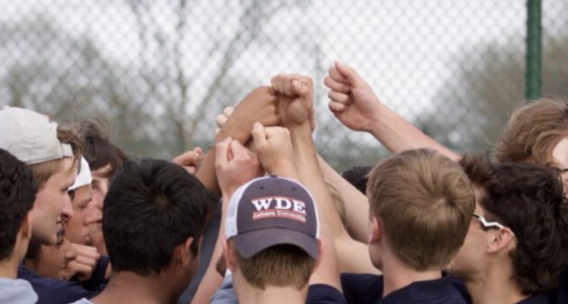 Picture of team huddling. Courtesy of Nick Schweitzer.