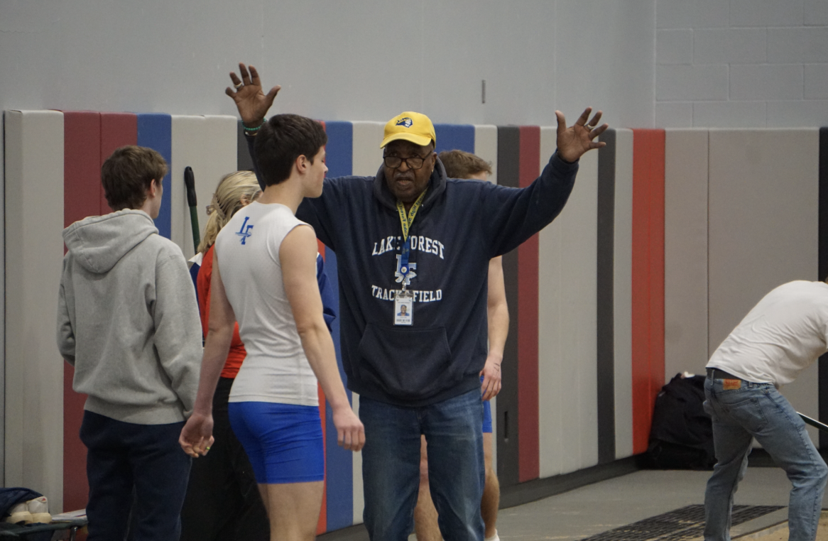 Coach Long showing one of his athletes the correct jumping form. Photo courtesy of John Brumund-Smith.